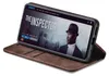 A smartphone in a brown flip case is displayed on a surface, showing a movie streaming interface on its screen. Produktbild-Vorschau