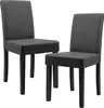 Two dark gray upholstered dining chairs with black wooden legs are shown against a white background. Náhled obrázku produktu