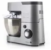 A silver kitchen mixer with a clear bowl and attachments, shown from a side angle on a white background. Podgląd zdjęcia produktu