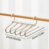 A multi-tiered hanger for pants or other clothing items, displayed on a clothing rack. Anteprima dell’immagine prodotto