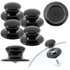 A collection of black pot lid handles arranged on a white background. Podgląd zdjęcia produktu