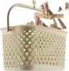 A beige laundry basket filled with wooden clothespins, with some clothespins spilling out. Podgląd zdjęcia produktu