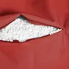 A close-up view of a red beanbag chair with its zipper partially open, revealing the white filling inside. Produktbild-Vorschau
