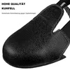 Close-up of a black safety shoe cover with text overlay. Produktbild-Vorschau