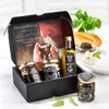 A gift set of truffle products displayed in an open box, with some accompanying ingredients and garnishes. Produktbild-Vorschau