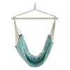 A teal fabric hammock chair suspended from a wooden bar and rope. Produktbild-Vorschau