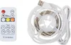 A white remote control and a white spool of LED strip lights are shown against a white background. Náhled obrázku produktu