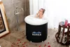 A woman is taking a bath in a portable bathtub. Produktbild-Vorschau
