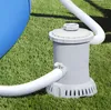 A pool filter pump connected to a blue pool, sitting on artificial grass. Produktbild-Vorschau