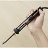 A hand holding a desoldering tool. Produktbild-Vorschau