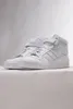 A pair of white Adidas Forum Mid sneakers are displayed against a light gray and white background. Produktbild-Vorschau