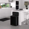 A modern kitchen with white cabinets and a black trash can. Produktbild-Vorschau