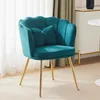 A teal velvet accent chair with gold legs and two small pillows sits on a light-colored carpet in a room with sheer curtains and a white cabinet in the background. Anteprima dell’immagine prodotto