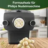 A black pasta maker attachment is shown on a wooden surface, with a pile of shell-shaped pasta in the foreground. A green banner at the top has text. A circular logo is in the lower left corner. Produktbild-Vorschau