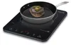 A steak is being cooked in a pan on a portable induction cooktop. Produktbild-Vorschau