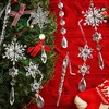 Christmas tree ornaments, including snowflakes and icicles, are displayed on a green Christmas tree and a red knitted background. Náhľad obrázku produktu