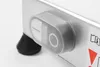 A close-up view of a control knob and a rubber foot on a silver appliance. Náhľad obrázku produktu