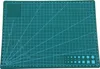 A green cutting mat with grid lines and angle markings. Produktbild-Vorschau