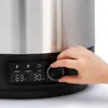 A hand is shown adjusting a dial on the control panel of a stainless steel appliance, likely a food or beverage warmer. Produktbild-Vorschau
