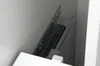 A close-up view of a drawer slide mechanism inside a cabinet. Voir les images du produit
