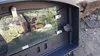 A close-up view of a pizza oven door with a landscape image visible through the glass. Produktbild-Vorschau