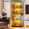 A woman sits on a couch holding a cup, looking at a display cabinet filled with figurines, with a smart sensor graphic overlay. Náhľad obrázku produktu