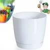 A white plastic plant pot with a saucer, shown next to a collage of other colored plant pots with plants. Náhled obrázku produktu