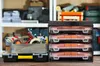 A collection of toolboxes and organizers on a wooden surface, with shelves of tools and supplies in the background. Produktbild-Vorschau