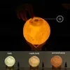 A hand touching a moon-shaped lamp, with three different color settings shown below. Podgląd zdjęcia produktu