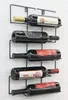 A black metal wine rack mounted on a white wall, holding five bottles of wine. Náhľad obrázku produktu