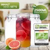 Three glass jars, one filled with a red and orange beverage and fruit slices, are displayed on a wooden surface. Two grapefruits are in the foreground. Marketing text and a quality seal are overlaid on the image. Produktbild-Vorschau