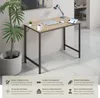 A desk in a modern room setting with a plant and a laptop on it. Náhled obrázku produktu