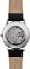 The back of a watch with its mechanical movement visible through a transparent case back, attached to a black leather strap. Voir les images du produit