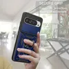 A hand holding a blue phone case with a ring stand, with a blurred indoor background. Produktbild-Vorschau