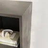 A close-up view of a shelf in a wardrobe with books and headphones. Náhled obrázku produktu