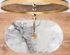 A top-down view of a marble sink with a gold faucet. Náhled obrázku produktu