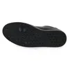 The underside of a black shoe is shown against a white background. Voir les images du produit
