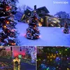A collage of images showing Christmas lights decorating trees, a house, and a fence in snowy and courtyard settings. Náhled obrázku produktu