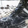 A close-up of a black construction boot with water splashing on it. Náhľad obrázku produktu