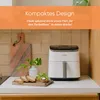 A white air fryer is on a kitchen counter next to some toast and a plant. Náhľad obrázku produktu