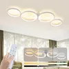 A hand holding a remote control in front of a modern LED ceiling light with multiple rings, with inset images showing different lighting modes. Produktbild-Vorschau