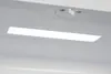 Interior view of a white appliance, likely a refrigerator, showing a light fixture and a switch. Produktbild-Vorschau