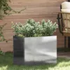 A stainless steel planter filled with green plants sits on a lawn in front of a wooden fence. Anteprima dell’immagine prodotto