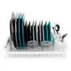 A white plastic dish rack with plates and cutlery drying. Produktbild-Vorschau