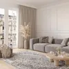 A modern living room with a gray sofa, a wooden coffee table, and a large patterned rug. Voir les images du produit