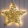 A decorative star-shaped light fixture hanging against a wooden wall. Anteprima dell’immagine prodotto
