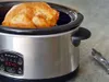 A roasted chicken sits inside a slow cooker on a countertop. Anteprima dell’immagine prodotto