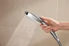 A hand holding a shower head with water spraying out. Anteprima dell’immagine prodotto