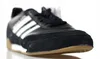 A close-up, studio shot of a black Adidas sneaker with white stripes. Anteprima dell’immagine prodotto