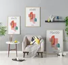 A living room scene with framed posters on the wall, a chair, and a side table. Produktbild-Vorschau